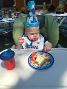 Child Eating Cake on First Birthday