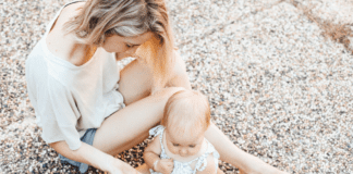 Mom sitting on sidewalk with baby