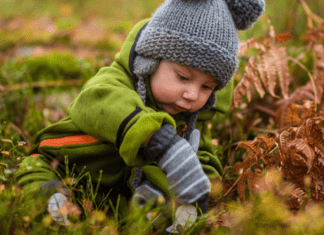 little kid playing in nature