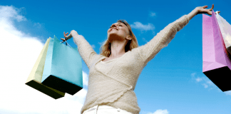 woman holding up shopping bags